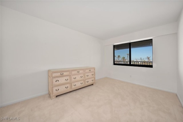 unfurnished bedroom featuring light carpet