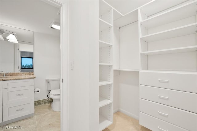 walk in closet featuring sink