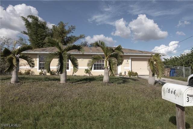 view of front facade with a garage and a front lawn