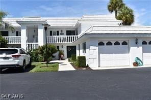 view of front facade with a balcony and a garage