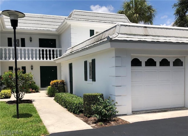 exterior space featuring a balcony and a garage