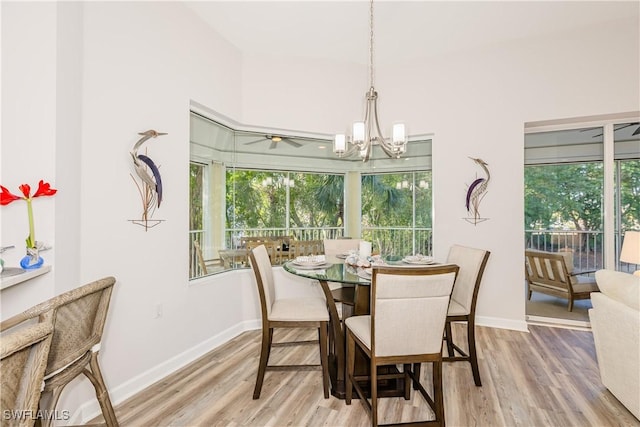 dining room with vaulted ceiling, a notable chandelier, and hardwood / wood-style flooring