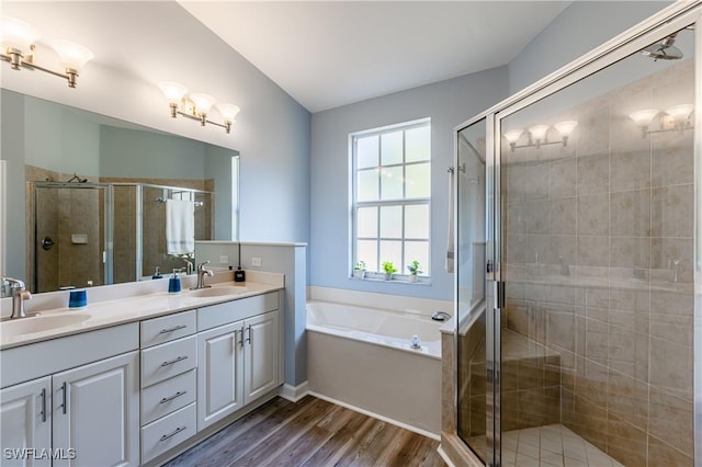 bathroom featuring hardwood / wood-style floors, vanity, and shower with separate bathtub