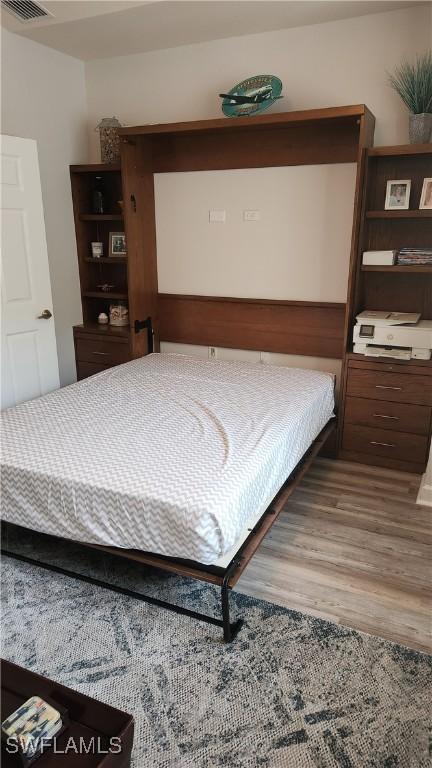 bedroom with wood-type flooring