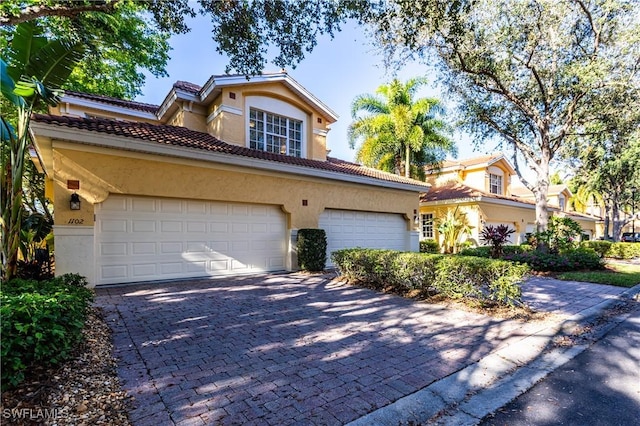 mediterranean / spanish home featuring a garage