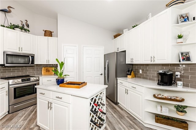 kitchen featuring light hardwood / wood-style flooring, white cabinets, and stainless steel appliances