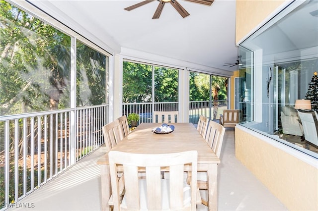 sunroom / solarium featuring ceiling fan