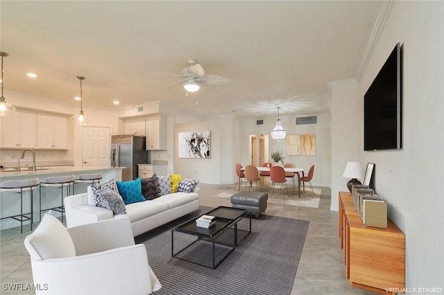 living room featuring sink, ceiling fan, and crown molding