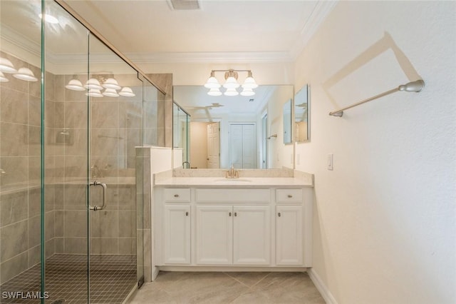 bathroom with ornamental molding, vanity, tile patterned floors, and a shower with shower door