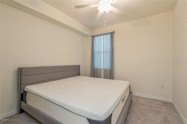 bedroom featuring light colored carpet and ceiling fan