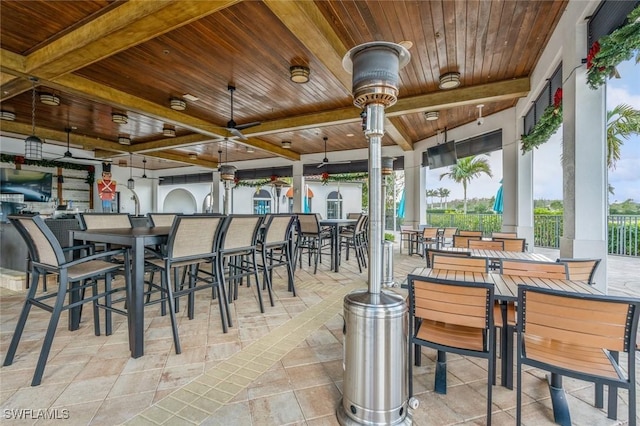 view of patio with a gazebo, a bar, and ceiling fan