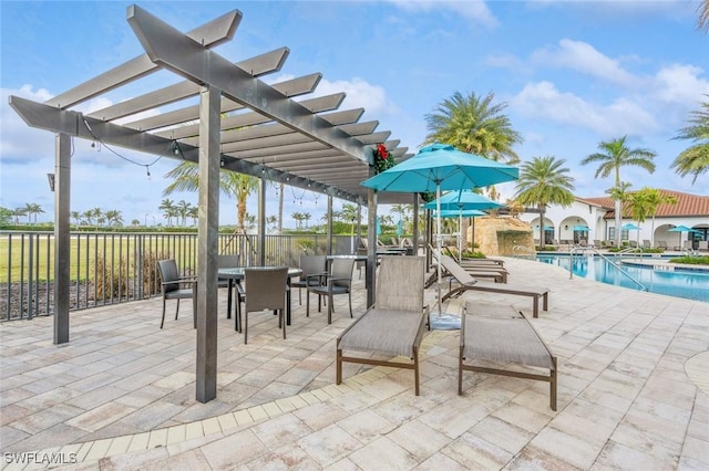 view of patio / terrace with a community pool and a pergola