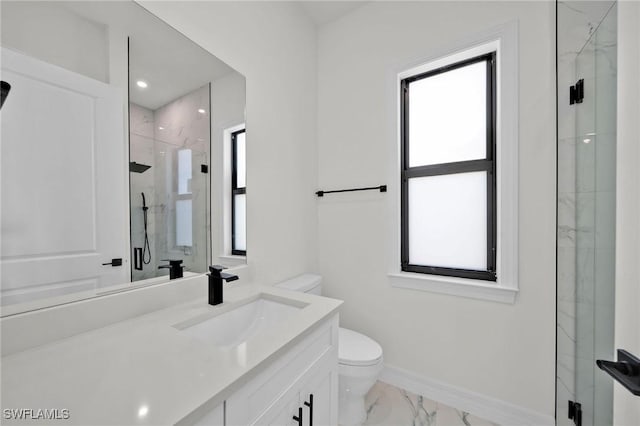 bathroom featuring vanity, an enclosed shower, and toilet