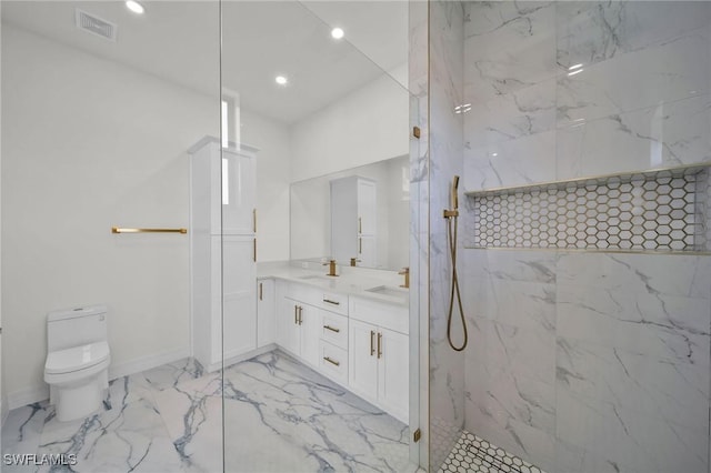 bathroom featuring vanity, toilet, and tiled shower