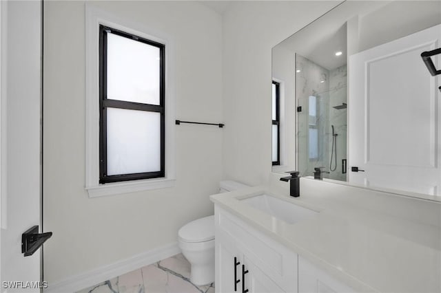 bathroom featuring vanity, toilet, and walk in shower