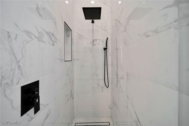 bathroom with a tile shower