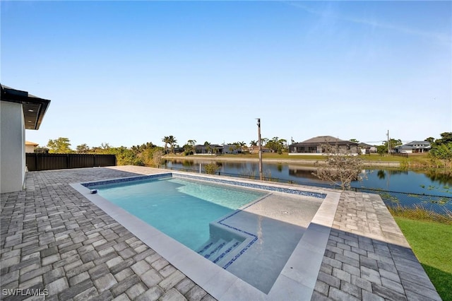 view of pool featuring a water view and a patio