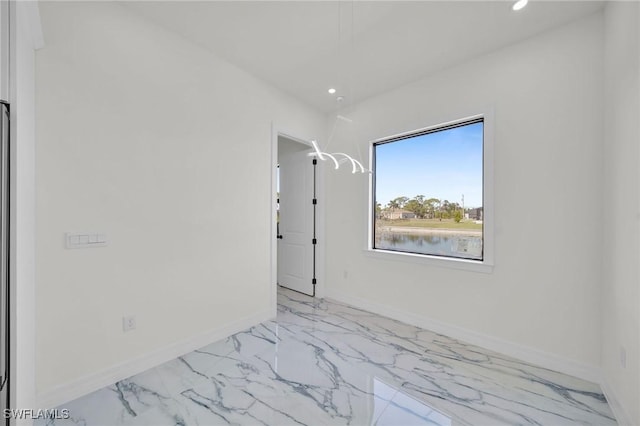 unfurnished room featuring a water view