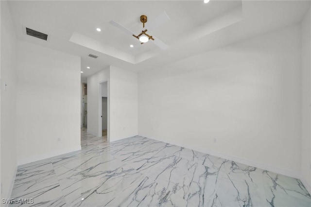 unfurnished room with a tray ceiling