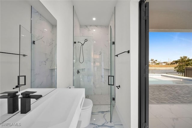 bathroom featuring an enclosed shower, toilet, and sink