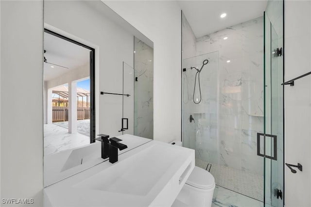 bathroom with toilet, an enclosed shower, and ceiling fan