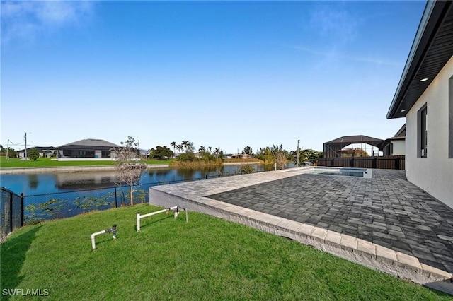 view of yard with a water view and a patio