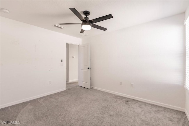 carpeted spare room featuring ceiling fan