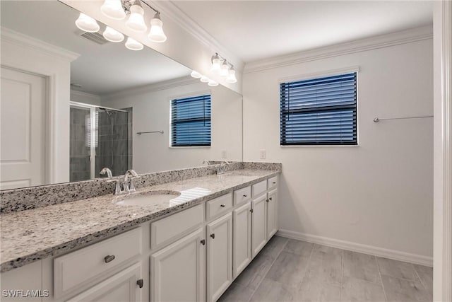 bathroom with vanity, a shower with door, and ornamental molding