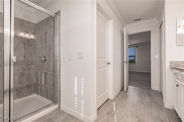 bathroom with vanity, a shower with shower door, and crown molding