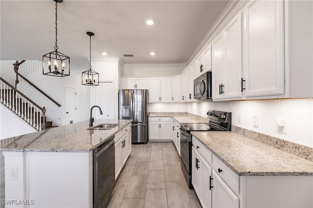 kitchen featuring sink, black appliances, a center island with sink, white cabinets, and hanging light fixtures