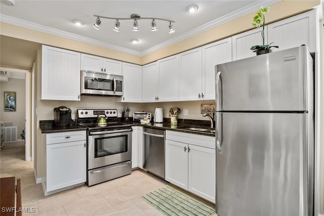 kitchen featuring white cabinetry, sink, ornamental molding, and stainless steel appliances