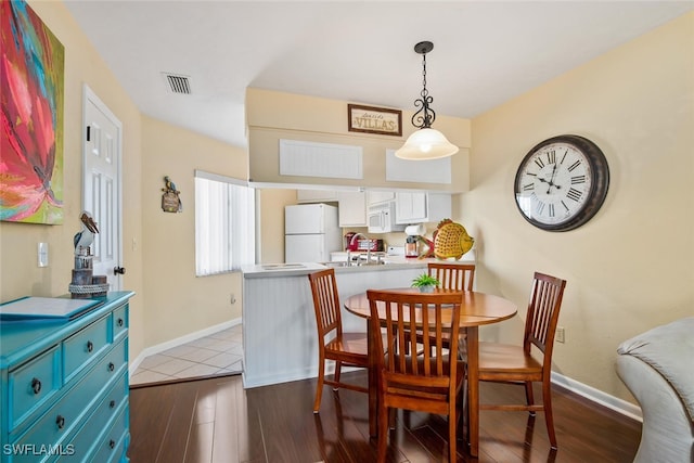 dining space with sink and light hardwood / wood-style floors