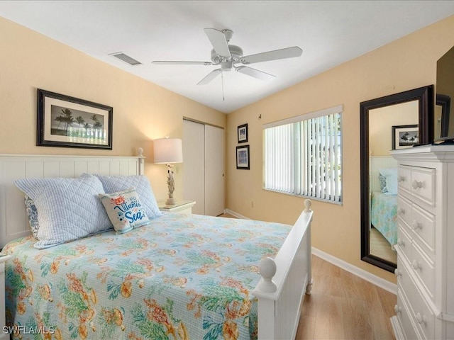 bedroom with ceiling fan, a closet, and light wood-type flooring