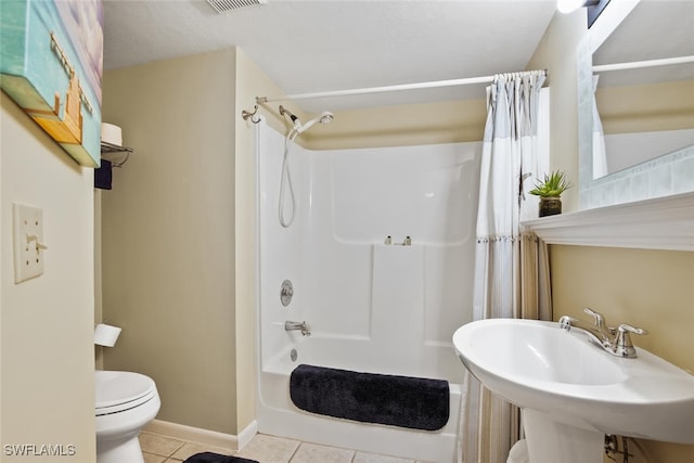 full bathroom with tile patterned flooring, sink, shower / tub combo, and toilet