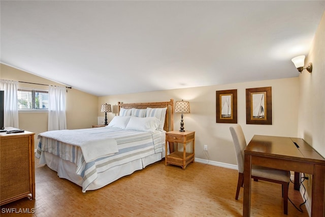 bedroom with lofted ceiling and hardwood / wood-style floors