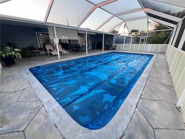 view of pool featuring a patio area and glass enclosure