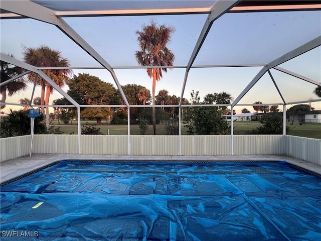 pool at dusk with glass enclosure