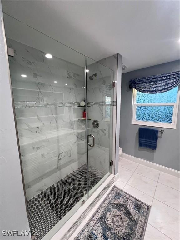 bathroom featuring tile patterned floors, toilet, and walk in shower