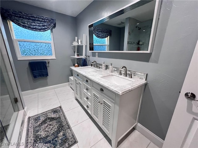 bathroom with vanity and a shower with shower door