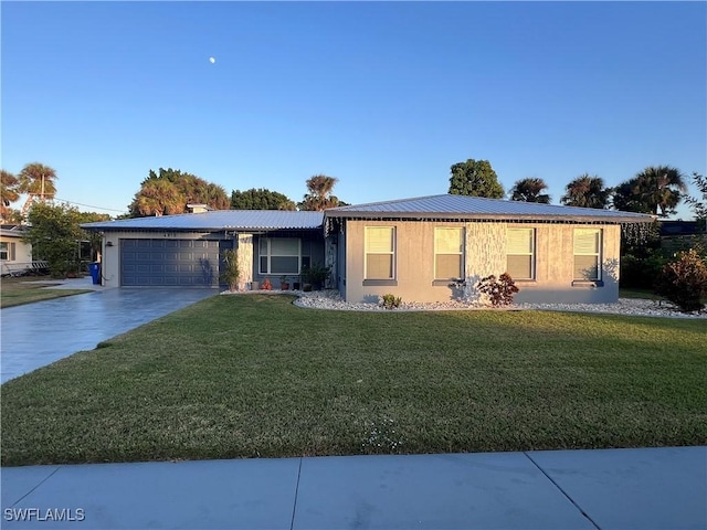 single story home featuring a garage and a front yard