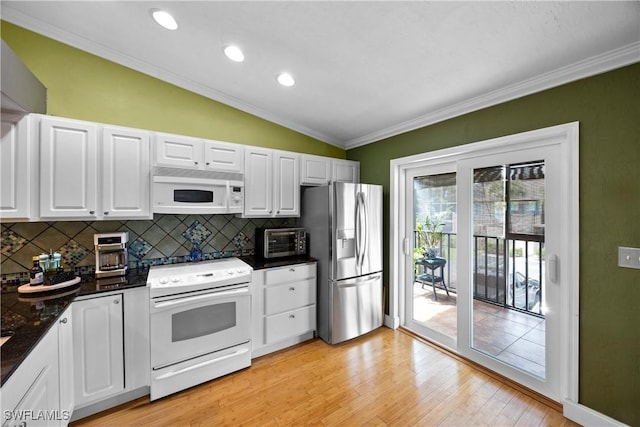 kitchen with light hardwood / wood-style flooring, vaulted ceiling, white appliances, white cabinets, and ornamental molding