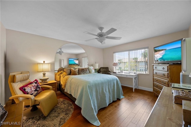 bedroom with ceiling fan and dark wood-type flooring