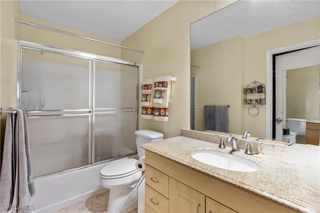 full bathroom with tile patterned flooring, vanity, toilet, and enclosed tub / shower combo