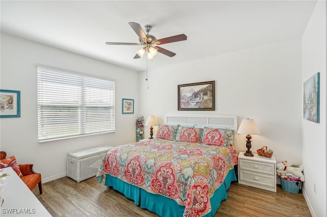 bedroom with hardwood / wood-style flooring and ceiling fan