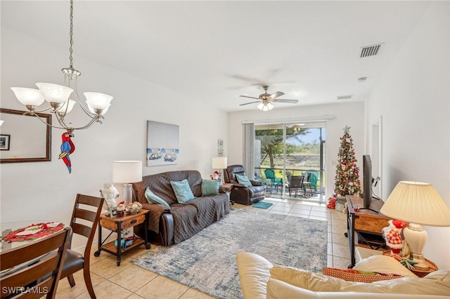 living room featuring light tile patterned floors and ceiling fan with notable chandelier