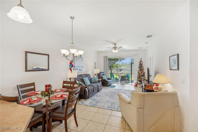 tiled living room featuring ceiling fan with notable chandelier