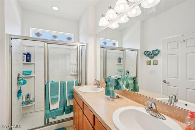 bathroom with a notable chandelier, vanity, and a shower with shower door