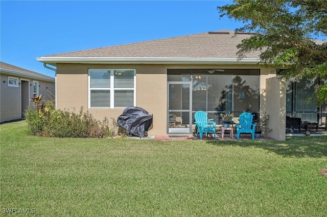 rear view of house with a sunroom and a yard