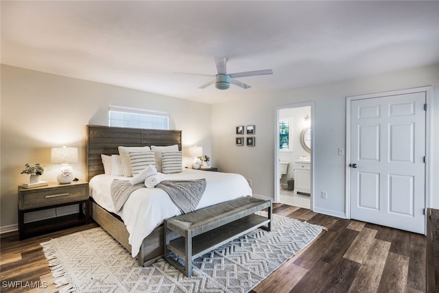 bedroom featuring ceiling fan, dark hardwood / wood-style floors, and connected bathroom