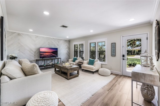 living room featuring light wood-type flooring and ornamental molding